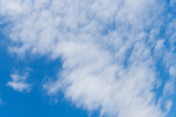 Obraz premium Blue Sky with Fluffy White Clouds on a Sunny Summer Day. Cloudscape - Blue sky and white clouds. Background cloud summer. Sky cloud clear with sunset. Natural sky