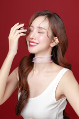 Obraz premium Young Asian Woman Holding Fresh Red Apple on Red Background.