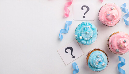 Flatlay of blue and pink confetti with question mark cupcakes for a gender reveal celebration featuring vibrant colors and festive decorations