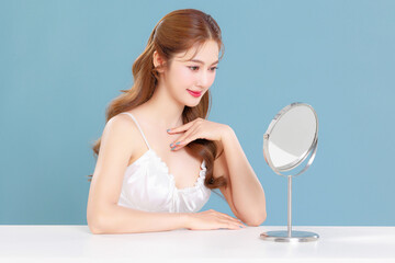 Pretty Asian beauty woman curly long hair with Korean makeup glowing face and healthy facial skin...