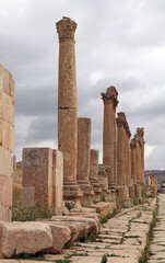 Row of broken columns and the original paving stones, Jerash Jordan
