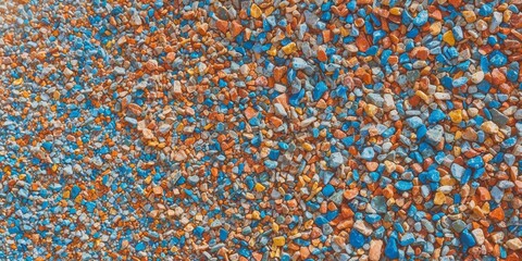 Fototapeta premium Aerial shot of colorful gravel surface with mixed stone colors.