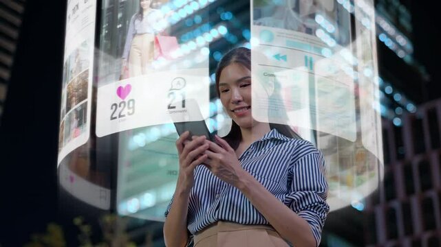 Beautiful asian woman is using an augmented reality smartphone to browse web pages,streaming,apps,search,and social networks.A woman uses her mobile phone while standing down a city street at night