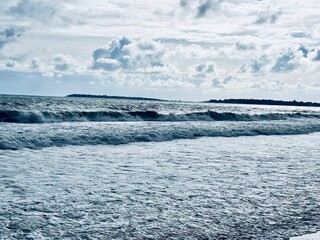 Waves on the sea and cloudy sky 