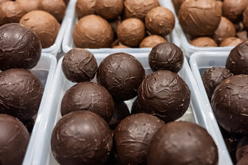 Close up of assorted chocolate truffles in various colors and textures. Colorful chocolate balls. Sweets handmade chocolate balls.
