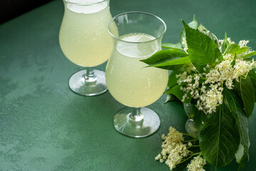 Carbonated elderflower drink. Flower summer kvass in glasses. Sparkling homemade hugo water. Elderberry food background