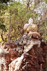 Golden Buddha Statue on Rock Asian Culture Spirituality Nature