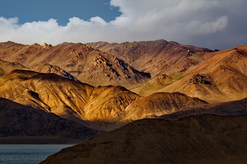 Tajikistan. A picturesque sunset in the valley of the mountainous desert lake Bulunkul on the...