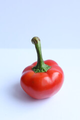 Red pepper on a white background. Close-up, selective focus.