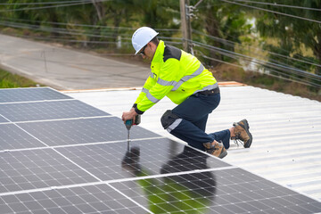 Men technicians mounting photovoltaic solar moduls on roof of house.