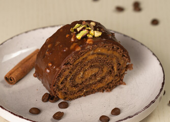 A sweet chocolate dessert with nut glaze and pistachio pieces, close-up