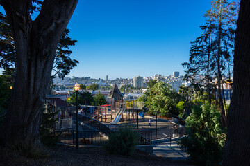 Alamo Square Playground, San Francisco, California, United States. Sunny day, clear blue sky and green trees.