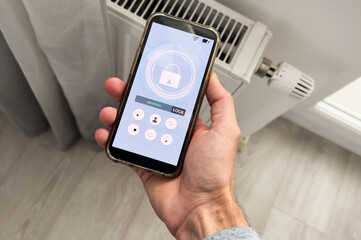 Smart house, home automation, device with App icons. Man uses his smartphone with smarthome app to control the lights of his house.