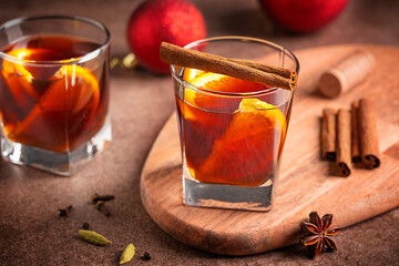 Portion of winter traditional red mulled wine drink or hot christmas punch with orange citrus...