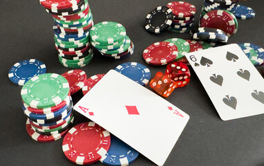 Poker cards and gambling chips on dark background