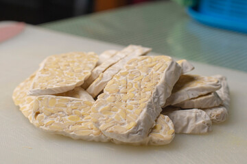 Stack the tempeh slices. Traditional food from fermented soybeans becomes tempeh.