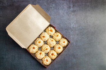 Moa is a traditional Bengali sweet made of puffed rice, jaggery, and coconut, often shaped into small, round balls.