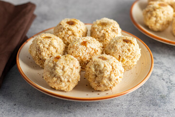 Moa is a traditional Bengali sweet made of puffed rice, jaggery, and coconut, often shaped into small, round balls.
