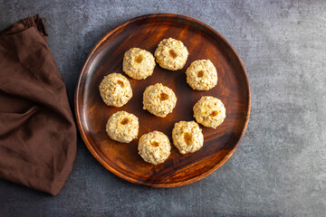 Moa is a traditional Bengali sweet made of puffed rice, jaggery, and coconut, often shaped into small, round balls.