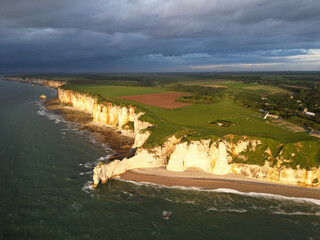 Aerial view of the famous white limestone cliffs near Etretat during sunset, France