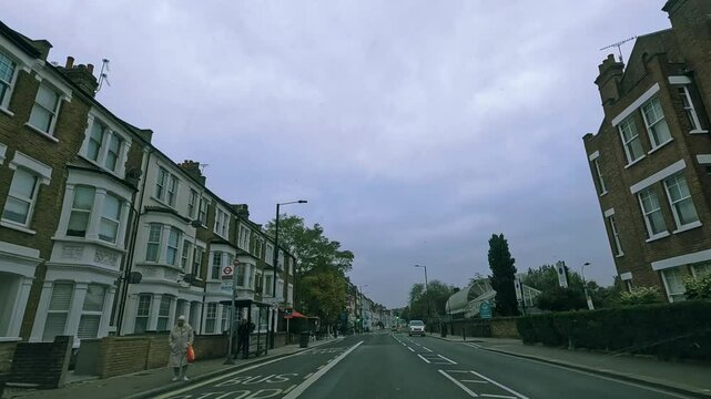 Exploring a tranquil suburban street with charming architecture and a cloudy sky in an English neighborhood in Putney, London
