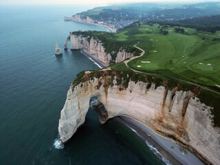 Aerial view of the famous white limestone cliffs near Etretat during sunset, France