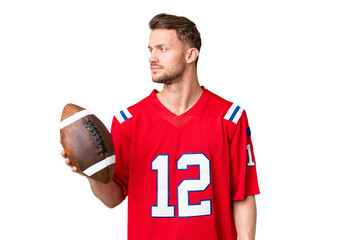 Young caucasian man playing rugby over isolated chroma key background looking to the side