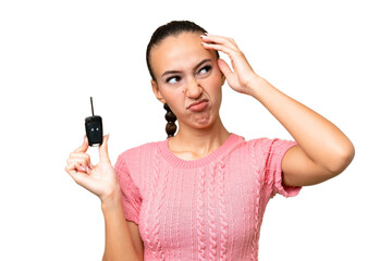 Young Arab woman holding car keys over isolated background having doubts and with confuse face expression