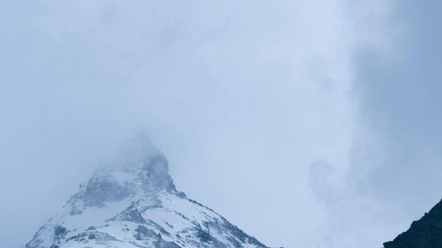 4K Time Lapse of clouds flowing over the snowy mountain peak. Himalayas during winter season. Cold winter day with snowy mountain peaks