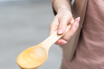 Wooden spoon in hand isolate