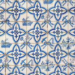 Fragment of church exterior facade. Dirty wall with colorful ceramic tiles. Azulejos, close up. Traditional ornate Portuguese architecture. Abstract background, textured ornate pattern.