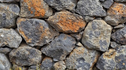 Obraz premium Close-up of a Stone Wall with Irregularly Shaped Rocks