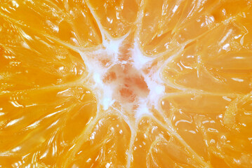 macro image of a cut of a juicy ripe orange tangerine