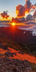 Naklejka premium Breathtaking Sunrise Over Majestic Mountains: A Panorama of Golden Hues and Clouds