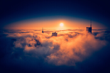 Beautiful panoramic fabulous, mesmerizing, unreal, aerial drone view of skyscrapers sticking out of low fog at sunrise, Warsaw, Poland, EU. VARSO - the tallest skyscraper in EU.