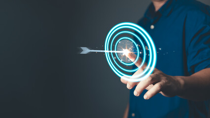 glow arrow hitting the center of a target symbolizes focus, purpose, mission, and the determination...