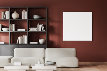 Minimalist living room with beige sofa, modern shelving, and blank framed poster on red wall background. 3D Rendering
