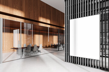 Blank white poster mockup on a black and wooden wall in a modern office conference room with glass...