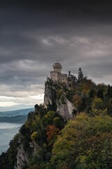 Naklejka premium Historic Castle on a Cliff with Moody Sky
