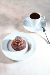 Pastry with custard. French pie Shu with peach jam. Modern dessert. Cup of coffee is on table.