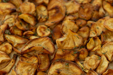Homemade parsnip chips background texture.