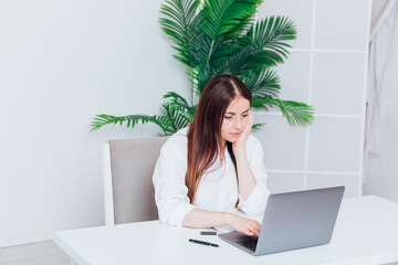 Business woman working online with laptop at desk in office