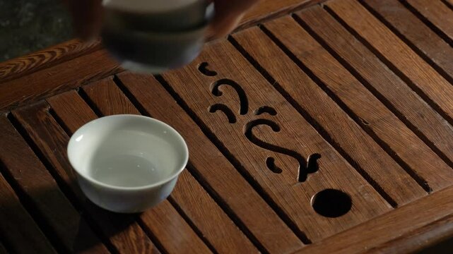 Tea ceremony on dark background. Preparing bowls. 