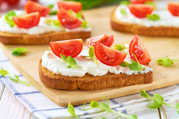 toast bread with cream cheese, cherry tomatoes and microgreens. Healthy breakfast concept.