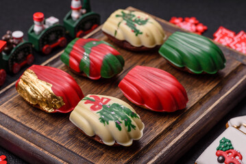 Sweet madeleine sponge cookies covered with colored chocolate