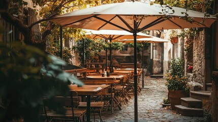 Charming Outdoor Cafe Surrounded by Lush Greenery and Rustic Decor, Inviting Ambiance with Umbrellas and Wooden Furniture in a Quaint Street Setting