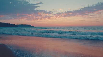 Obraz premium Tranquil seaside view at dusk with gentle waves lapping on the shore, vibrant pastel sky reflecting on the calm water surface, inviting nature's serenity and beauty.