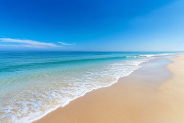 Obraz premium Beautiful shoreline under a clear blue sky with gentle waves lapping at the sand