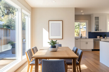 Fototapeta premium Bright dining room with a wooden dining table, blue upholstered chairs, large windows, and a wall art mock-up frame for a warm and inviting atmosphere