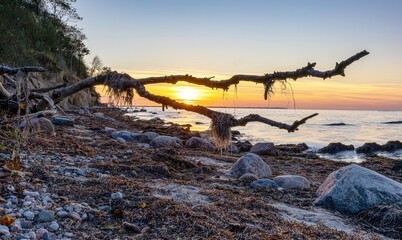 Sunset on the rocky cliff with demolition on the island of Poel